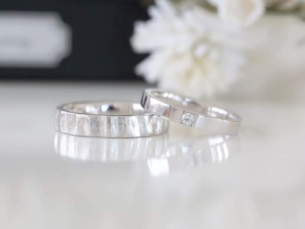 幅広平打ちリングにヤスリ目のテクスチャーと幅細平打ちリングにメレーダイヤが石留された結婚指輪２本